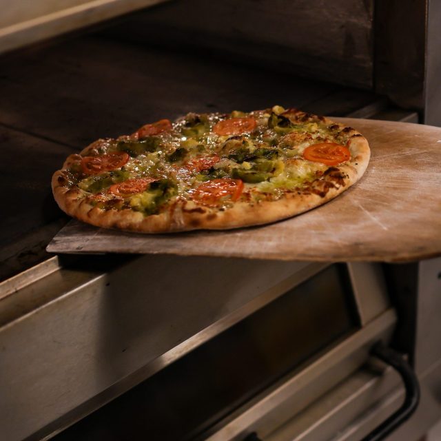 Pizza going in the oven